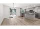 Open-concept kitchen with stylish wood flooring, stainless steel appliances, and access to the deck at 3195 Newcastle Way, Snellville, GA 30039