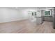 Open-concept kitchen and living room with stylish wood flooring and stainless steel appliances at 3195 Newcastle Way, Snellville, GA 30039