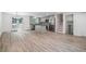 Open-concept kitchen and living room with stylish wood flooring and modern stainless steel appliances at 3195 Newcastle Way, Snellville, GA 30039