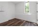 Clean and bright bedroom featuring wood floors, a large window, and neutral paint at 367 Parkway Ne Dr # 7, Atlanta, GA 30312