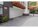 Private brick-paved driveway leading to a detached garage with wooden balconies above at 367 Parkway Ne Dr # 7, Atlanta, GA 30312