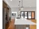 Modern kitchen with a large island, white countertops, wood cabinets, stainless steel appliances, and stylish pendant lighting at 367 Parkway Ne Dr # 7, Atlanta, GA 30312