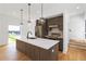 Modern kitchen with a large island, white countertops, wood cabinets, stainless steel appliances, and stylish pendant lighting at 367 Parkway Ne Dr # 7, Atlanta, GA 30312
