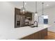 Modern kitchen with a large island, white countertops, wood cabinets, stainless steel appliances, and stylish pendant lighting at 367 Parkway Ne Dr # 7, Atlanta, GA 30312
