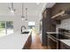 Modern kitchen with a large island, white countertops, wood cabinets, stainless steel appliances, and stylish pendant lighting at 367 Parkway Ne Dr # 7, Atlanta, GA 30312