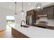 Modern kitchen with a large island, white countertops, wood cabinets, stainless steel appliances, and stylish pendant lighting at 367 Parkway Ne Dr # 7, Atlanta, GA 30312