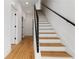 Elegant staircase with wood treads, white risers, a modern black railing, and natural light at 367 Parkway Ne Dr # 7, Atlanta, GA 30312