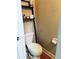 Toilet room with wood floors and an organizational shelf above at 5771 Vinings Retreat Sw Way, Mableton, GA 30126