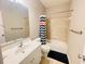 Bathroom with a shower-tub combination, tile surround, and single sink vanity with ample lighting at 5771 Vinings Retreat Sw Way, Mableton, GA 30126
