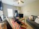 Bedroom with carpet, ceiling fan, gray sofa, colorful rug and desk at 5771 Vinings Retreat Sw Way, Mableton, GA 30126