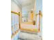 Hallway with carpeted floors and wooden banisters leading to the upper level, offering a bright and welcoming space at 5771 Vinings Retreat Sw Way, Mableton, GA 30126