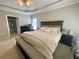 Spacious main bedroom with a bed, bench, nightstands, dressers, and access to the main bathroom at 5771 Vinings Retreat Sw Way, Mableton, GA 30126