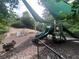 Community playground with play structures, shade and surrounding woods at 5771 Vinings Retreat Sw Way, Mableton, GA 30126