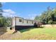 Spacious backyard featuring a wooden deck, a partial fence and mature trees, perfect for outdoor relaxation at 136 Fairlane Dr, Covington, GA 30016
