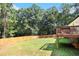 Expansive backyard featuring a well-maintained lawn, a wooden fence, and a deck for outdoor living at 136 Fairlane Dr, Covington, GA 30016