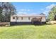 Backyard view featuring a deck, a well-maintained lawn, and a wooden privacy fence at 136 Fairlane Dr, Covington, GA 30016