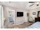 Bedroom featuring access to an ensuite bath, a TV, and natural light from the windows at 136 Fairlane Dr, Covington, GA 30016