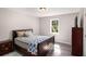 Bedroom with natural light, hardwood floors, and traditional decor at 136 Fairlane Dr, Covington, GA 30016