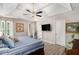 Spacious bedroom with a tray ceiling, a ceiling fan, a TV, and natural light from the windows at 136 Fairlane Dr, Covington, GA 30016