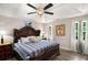 Comfortable bedroom featuring a decorative headboard, bedside lamps, and natural light from the windows at 136 Fairlane Dr, Covington, GA 30016