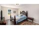 Cozy bedroom featuring a decorative headboard, rug, and bedside table with a view from the window at 136 Fairlane Dr, Covington, GA 30016