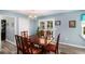 Cozy dining area with modern lighting, seamlessly connecting to the kitchen and patio at 136 Fairlane Dr, Covington, GA 30016
