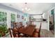 Inviting dining area with modern lighting, seamlessly connecting to the kitchen and outdoor patio at 136 Fairlane Dr, Covington, GA 30016