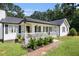 Charming home with a welcoming porch and garden, showcasing a well-maintained exterior at 136 Fairlane Dr, Covington, GA 30016