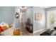 Hallway features light blue walls, wood floors, white trim, and decorated with wall hangings at 136 Fairlane Dr, Covington, GA 30016