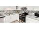 Kitchen features stainless steel appliances, gray countertops, and ample storage space at 136 Fairlane Dr, Covington, GA 30016