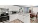 Bright kitchen with stainless steel oven, microwave, white cabinets, and breakfast bar adjacent to dining area at 136 Fairlane Dr, Covington, GA 30016