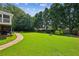 Expansive backyard with lush green grass, providing a serene and private outdoor space for relaxation and recreation at 1506 Threepine Place Pl, Lilburn, GA 30047