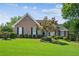 Charming brick home featuring a manicured lawn and tasteful landscaping, creating a welcoming curb appeal at 1506 Threepine Place Pl, Lilburn, GA 30047
