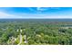 Distant aerial view of neighborhood, showcasing many mature trees and well-maintained lawns in residential area at 5148 Coolamber Dr, Powder Springs, GA 30127