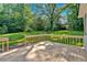 A wooden back deck overlooks a large, grassy lawn surrounded by mature trees, creating a private outdoor retreat at 5148 Coolamber Dr, Powder Springs, GA 30127