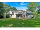 The backyard offers an expansive lawn, screened porch, and deck, creating an inviting space for relaxation and gatherings at 5148 Coolamber Dr, Powder Springs, GA 30127