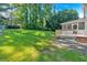 A sprawling backyard features a well-maintained lawn and leads to a porch and deck, perfect for outdoor relaxation at 5148 Coolamber Dr, Powder Springs, GA 30127