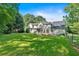 This well-manicured backyard showcases a spacious lawn, deck, and screened porch, ideal for outdoor entertaining at 5148 Coolamber Dr, Powder Springs, GA 30127