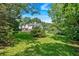 Backyard with mature trees surrounds a house with deck and porch at 5148 Coolamber Dr, Powder Springs, GA 30127