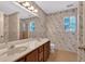 Bathroom featuring a wallpapered design, double sinks, and a large mirror at 5148 Coolamber Dr, Powder Springs, GA 30127