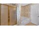 Bathroom with shower, tub, and patterned wallpaper creates a relaxing space at 5148 Coolamber Dr, Powder Springs, GA 30127