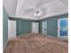 Spacious bedroom with tray ceiling, ceiling fan, two windows, and neutral color scheme at 5148 Coolamber Dr, Powder Springs, GA 30127