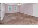 Large bedroom featuring two windows, a ceiling fan, and a neutral color scheme at 5148 Coolamber Dr, Powder Springs, GA 30127
