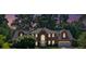 Charming brick home with an attached garage, featuring a well-manicured lawn and mature trees at 5148 Coolamber Dr, Powder Springs, GA 30127
