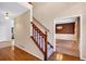Foyer with hardwood floors with staircase and classic wallpaper at 5148 Coolamber Dr, Powder Springs, GA 30127