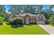 Beautiful brick home with mature trees and lush green lawn at 5148 Coolamber Dr, Powder Springs, GA 30127