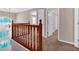 Hallway with wooden banister and a view of a large window at 5148 Coolamber Dr, Powder Springs, GA 30127