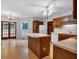 Traditional kitchen featuring an island, white appliances, wood cabinets and glass doors to the outside at 5148 Coolamber Dr, Powder Springs, GA 30127