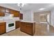Traditional kitchen with tile floors, wood cabinets, a center island, and white appliances at 5148 Coolamber Dr, Powder Springs, GA 30127