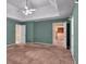 Primary bedroom featuring tray ceilings, carpet and a private bath at 5148 Coolamber Dr, Powder Springs, GA 30127